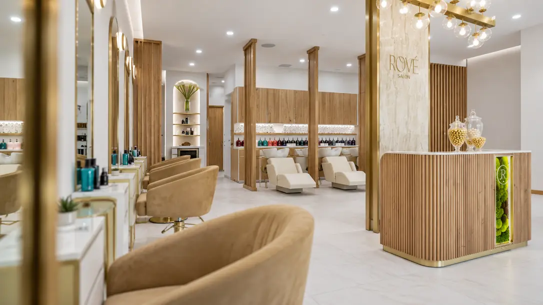 Side-angle editorial view of Rové’s styling stations, reception desk and wash area