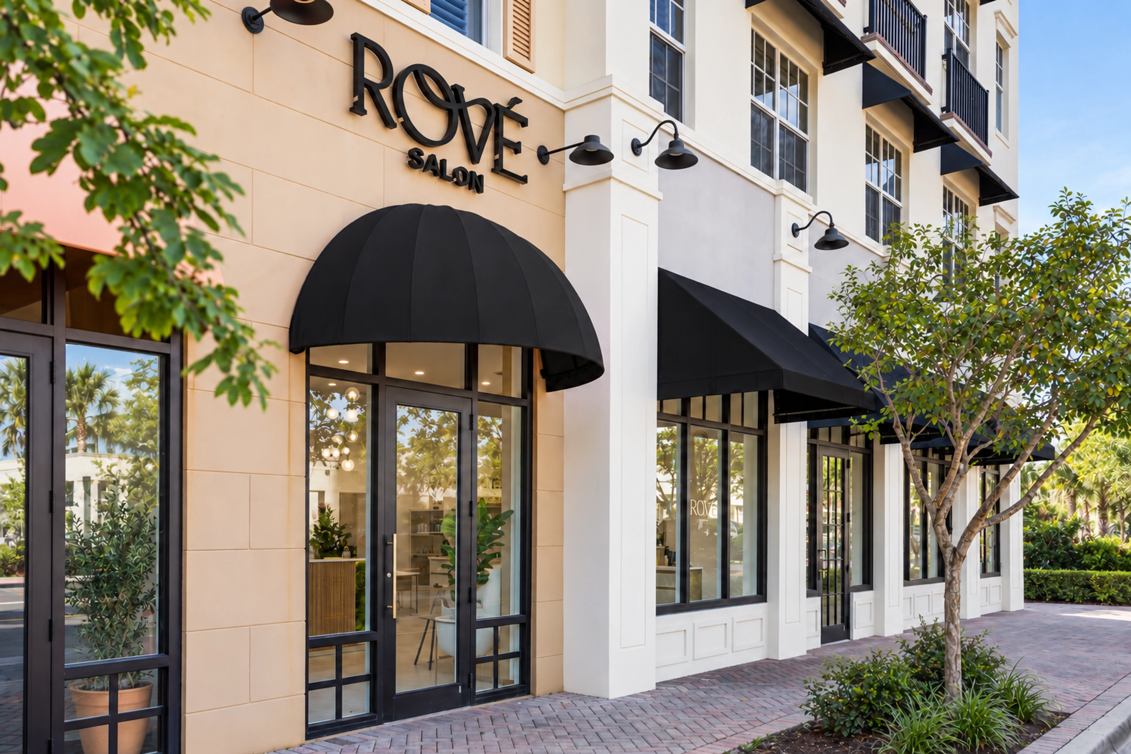 Rové’s entrance on NE 2nd Avenue in daylight, framed by trees and black awnings