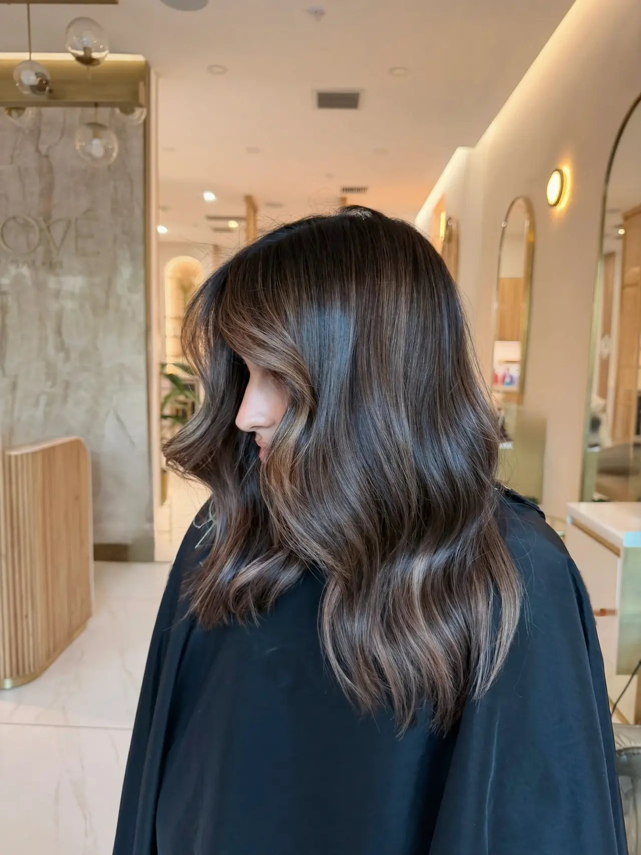 Glossy deep brunette waves in a shoulder-length cut at Rové