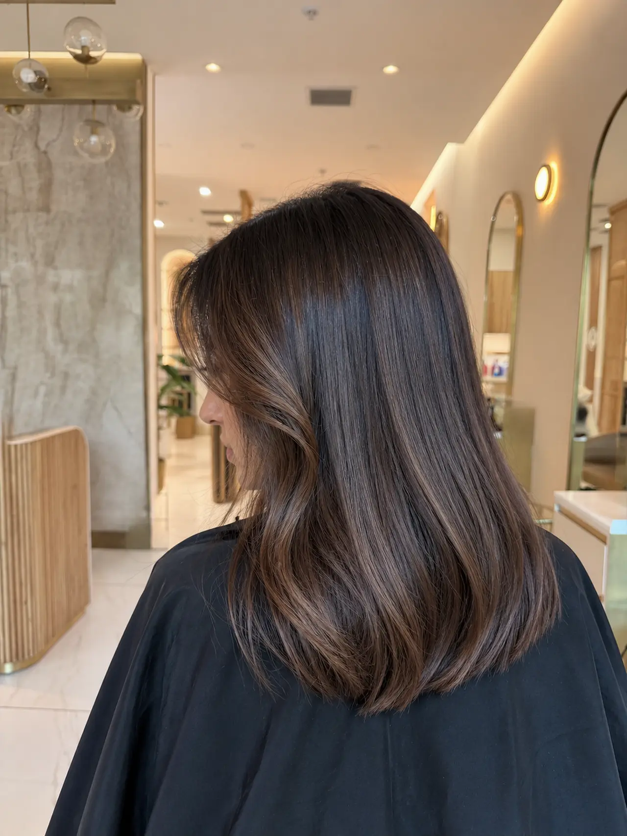 Smooth brunette hair with a gentle bend and softly curved ends