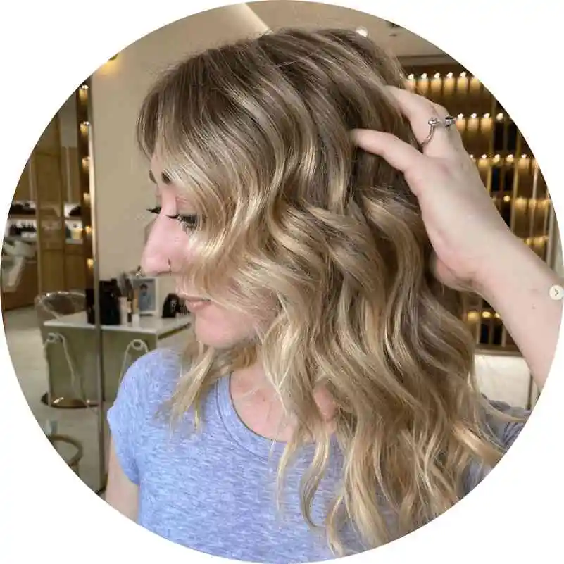 Expert application of hair color remover and toner.